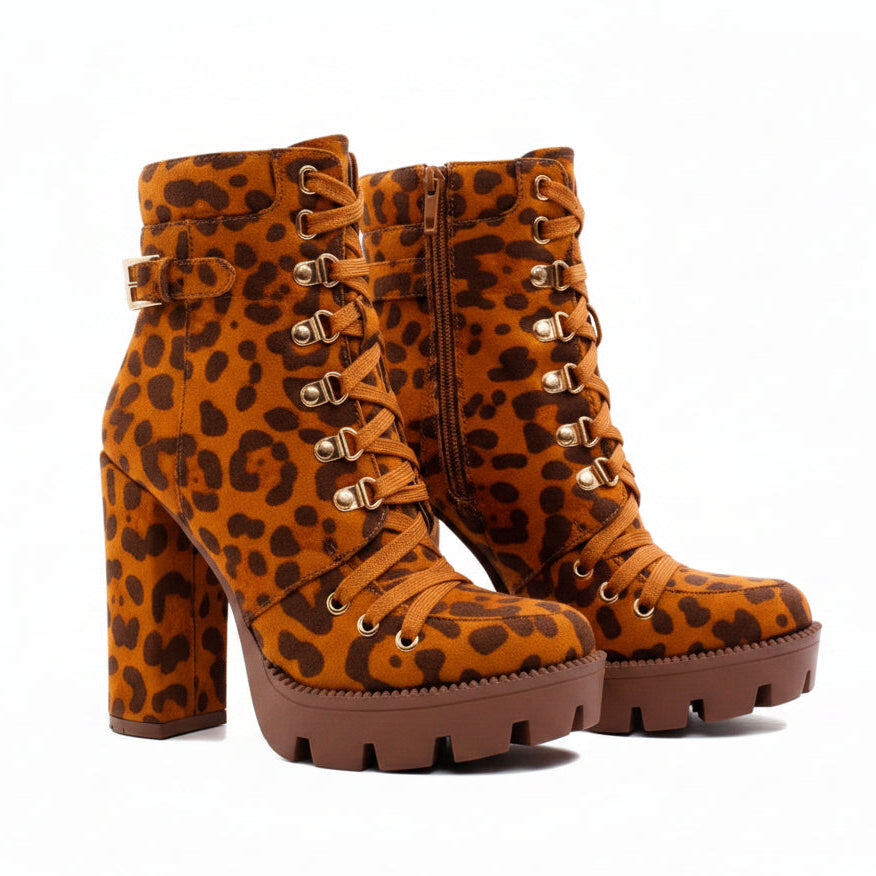 Leopard print high-heeled boots worn by a person on a white background
