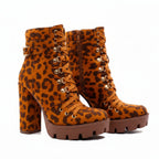 Leopard print high-heeled boots worn by a person on a white background