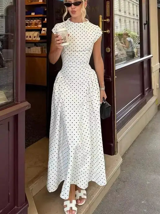 Women's white polka dot maxi dress, perfect for summer outings.