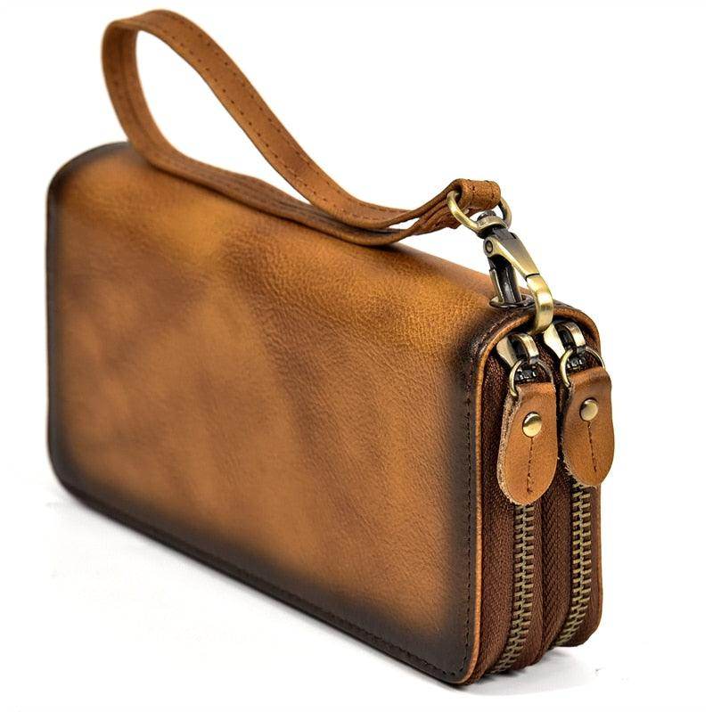 Brown crazy horse leather wallet featuring dual zippers and wrist strap for stylish organization