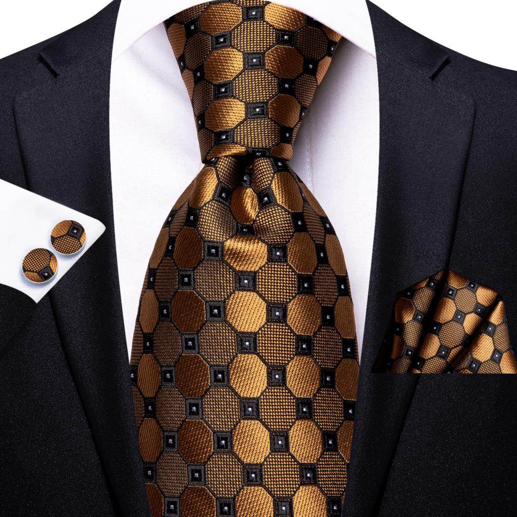 Designer wedding ties for men featuring a black and gold patterned tie with matching pocket square and cufflinks