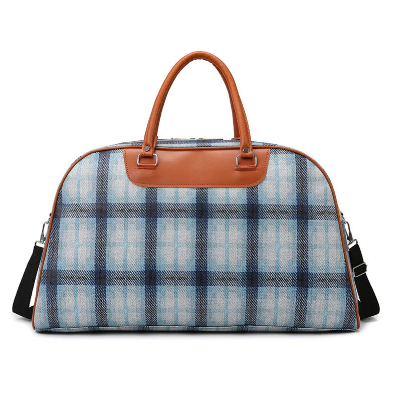 Plaid duffle bag with tan leather accents, perfect for travel
