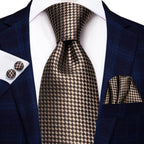 Gold paisley formal tie paired with a dark suit and patterned pocket square for a sophisticated look