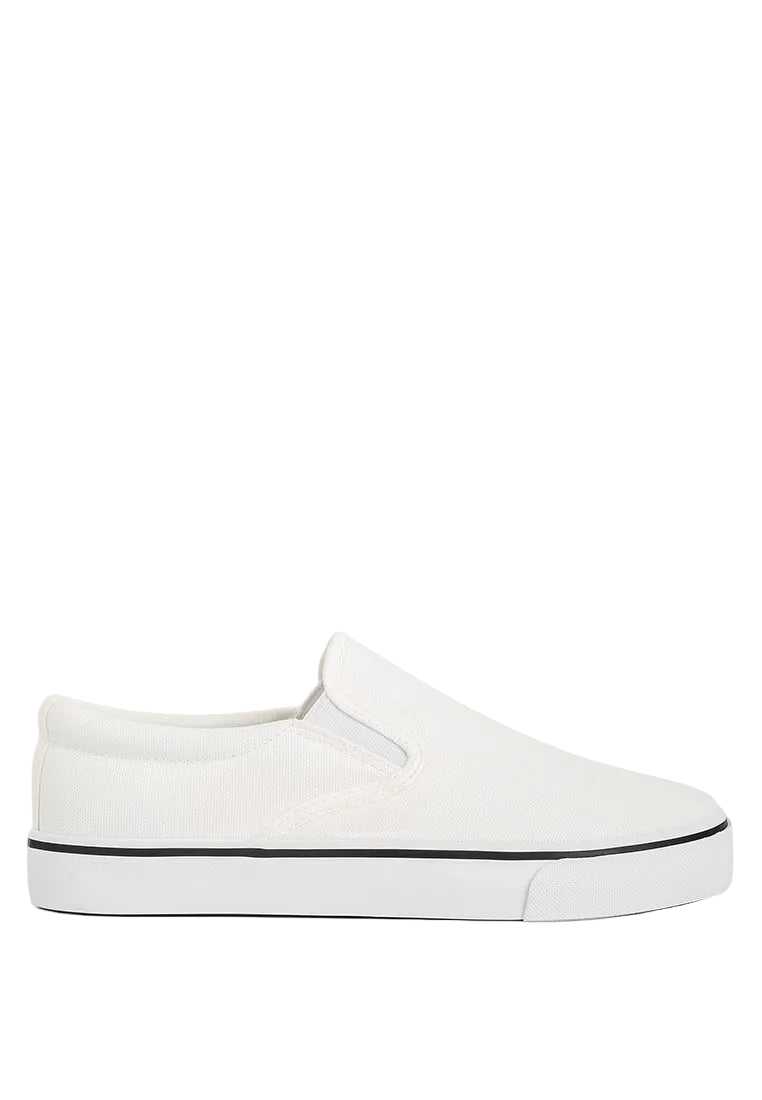 White slip-on sneaker with black sole on a light blue background