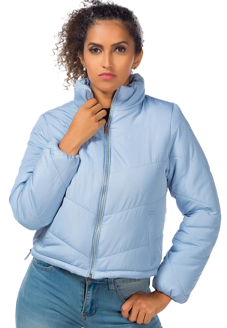 Woman wearing a light blue puffer jacket on a white background