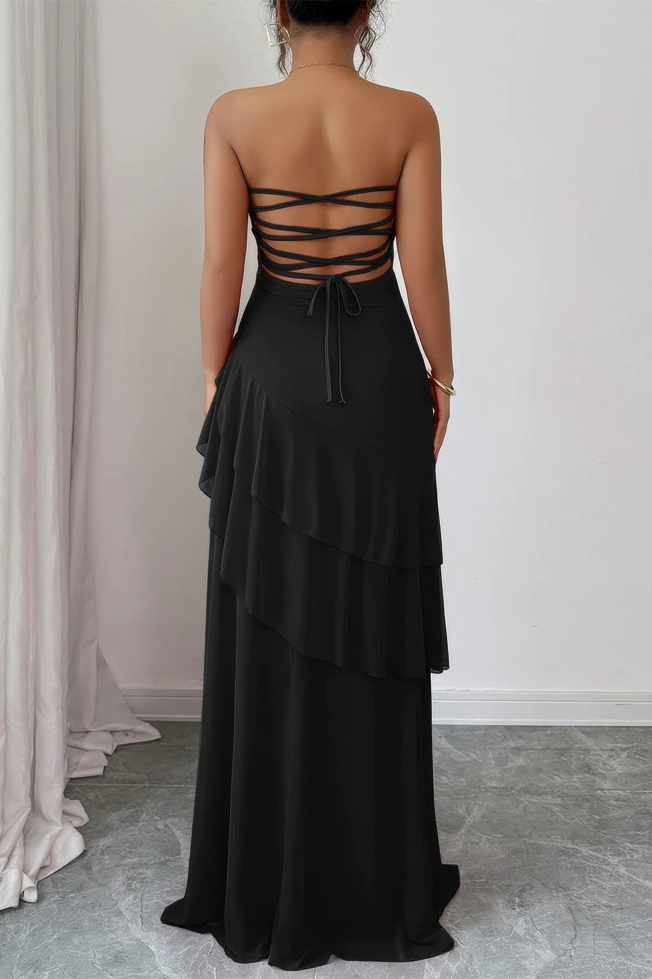Black strapless maxi dress with tiered ruffles, perfect for summer events