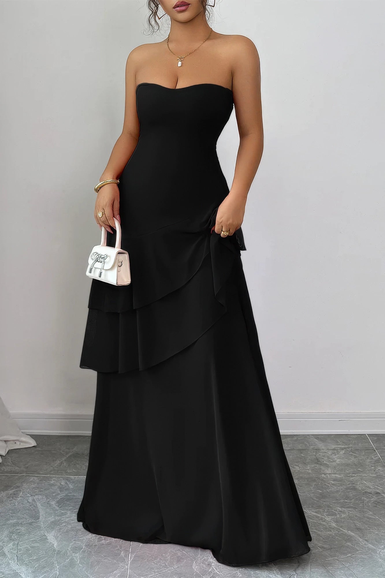 Elegant black strapless dress with layered design for evening events and maxi dress.