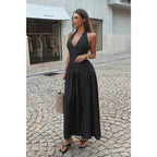 Women's black polka dot halter neck maxi dress, perfect for summer outings.