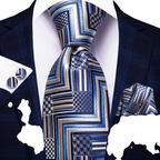 Blue patterned tie with matching pocket square and cufflinks on a suit jacket.