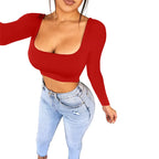 Woman wearing a red sexy summer crop top for women with long sleeves paired with light blue jeans