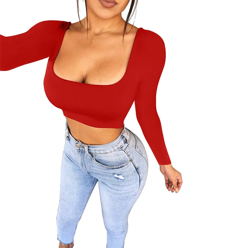 Woman wearing a red sexy summer crop top for women with long sleeves paired with light blue jeans