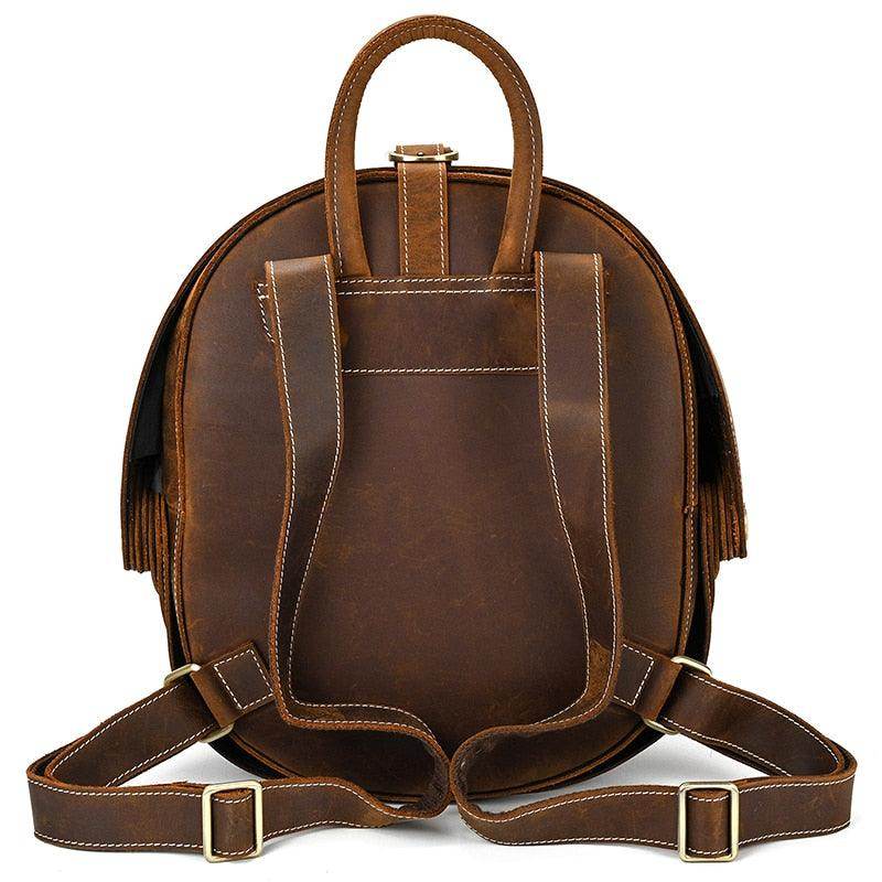 Accordion beetle daypack in brown leather with dual straps and top handle for easy carrying